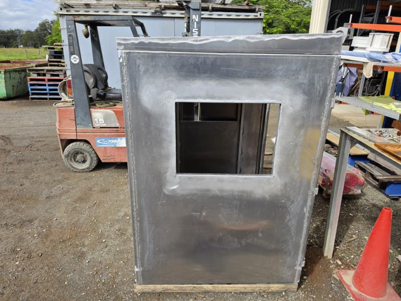 Custom aluminium enclosure with a cut-out window, fabricated in the workshop yard