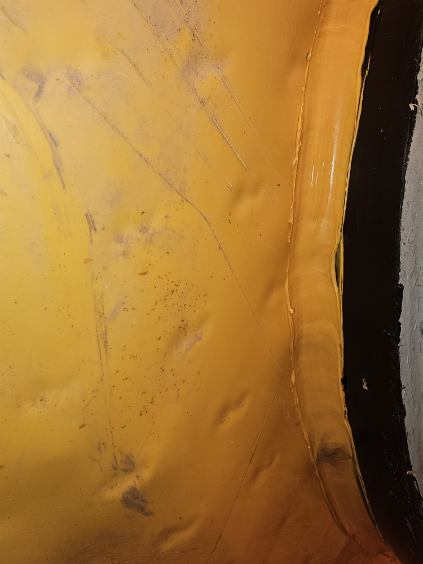 Close-up of an extrusion welded seam in yellow HDPE sheet