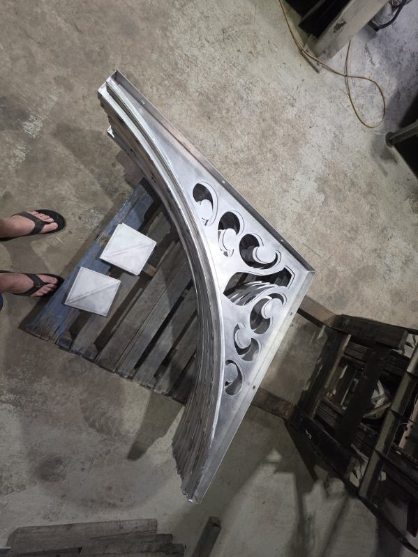 Decorative curved alloy panel with laser-cut scroll detailing