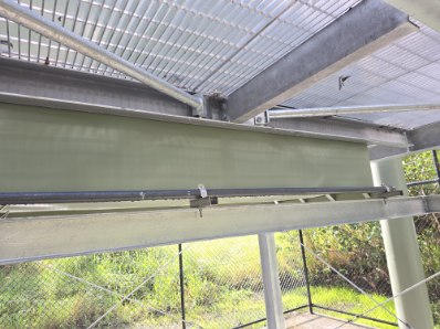 Steel framing and pipe bracketry beneath the walkway grating