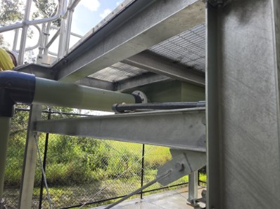 Underside of the platform showing beams, grating and pipe supports