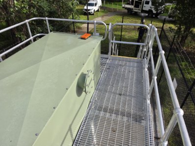 Grated walkway and handrail installed alongside a dosing tank