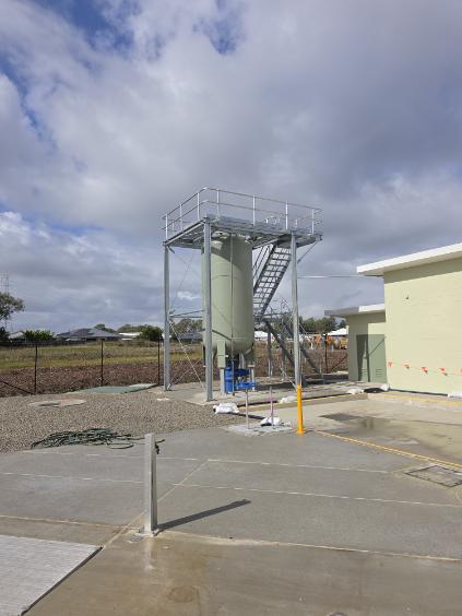 Completed steel tower structure with silo, access stair and handrails